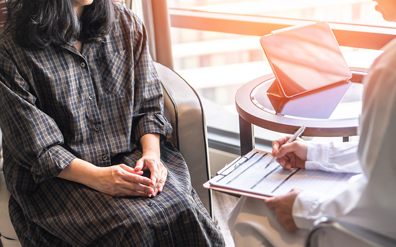 A woman receiving a consultation at a gynaecologist clinic