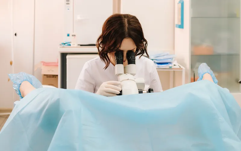Gynaecologist performing a colposcopy